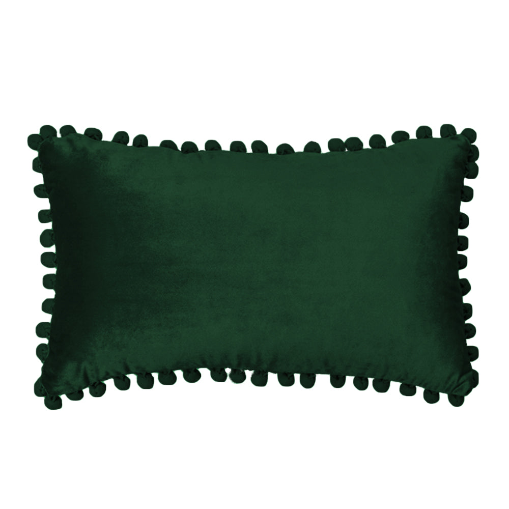 Green pillow with pom-pom trim on a white background