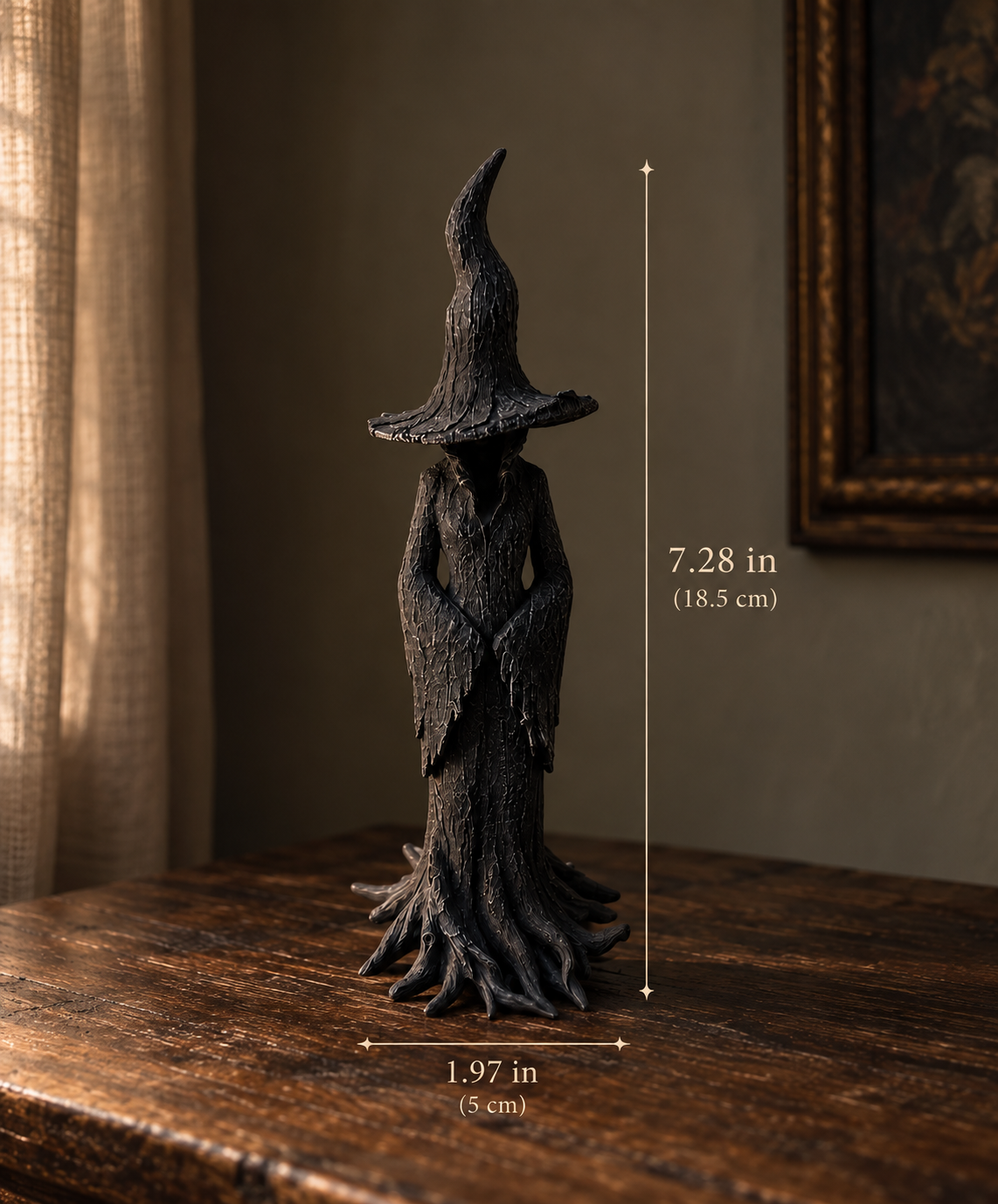 A dark, textured witch figurine standing on a wooden table in a dimly lit room, with measurement overlays showing its height of 7.28 in (18.