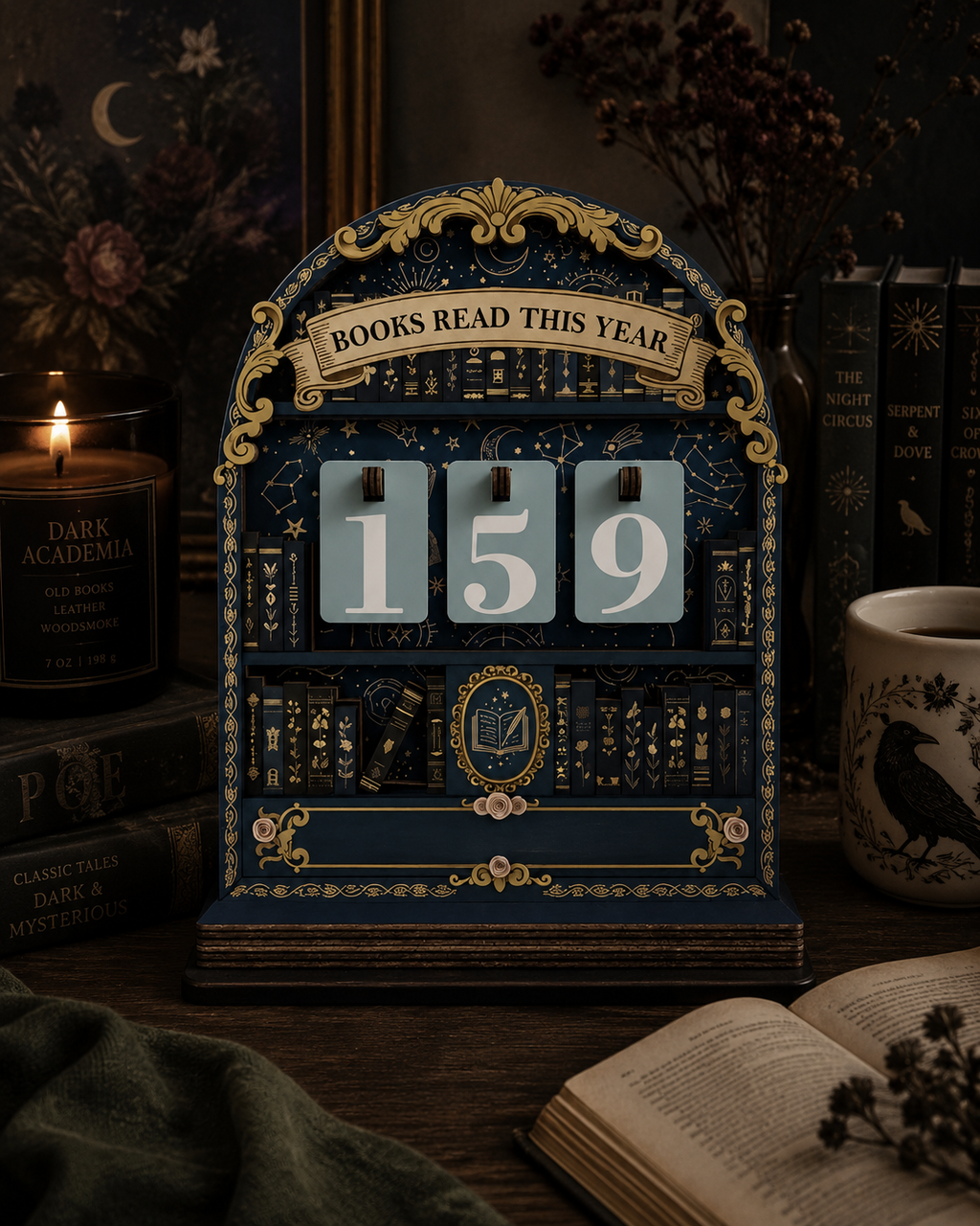 A decorative vintage-style flip calendar styled on a dark wooden table, displaying the number 159. The calendar is navy blue with ornate gold detailing and book illustrations.