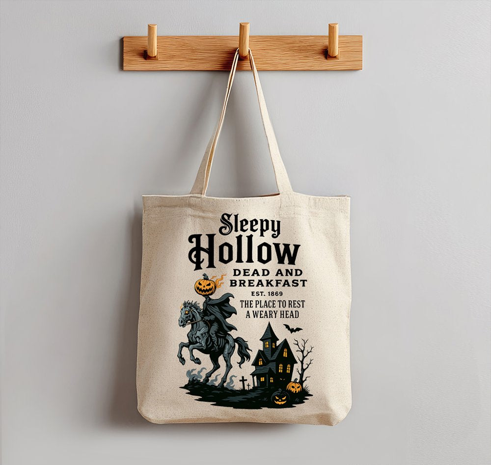 Tote bag with 'Sleepy Hollow' design hanging on a wooden hook against a gray wall.