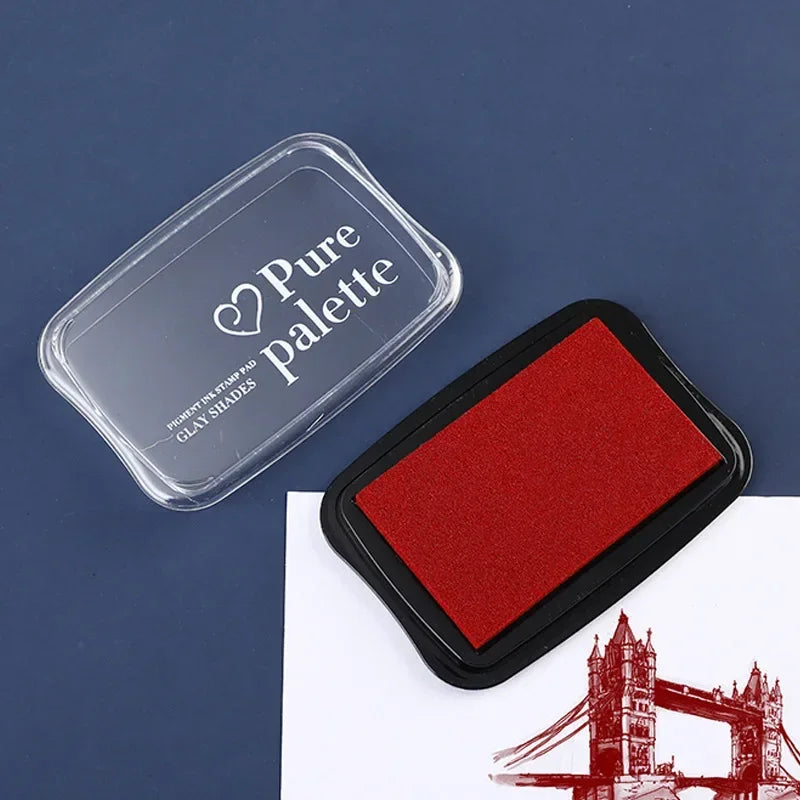 Red ink pad with 'Pure Palette' branding on a blue background