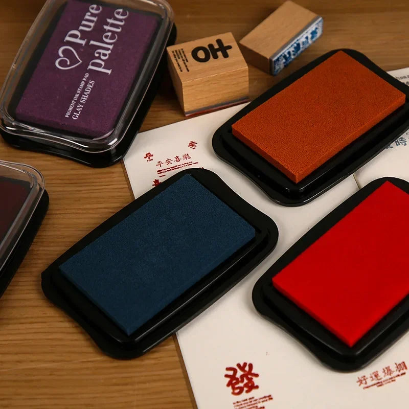 Set of stamp pads with different colors on a wooden surface