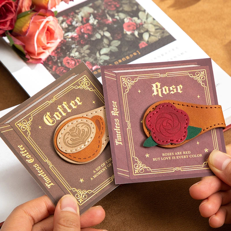 Two decorative cards with 'Coffee' and 'Rose' designs held by a hand.
