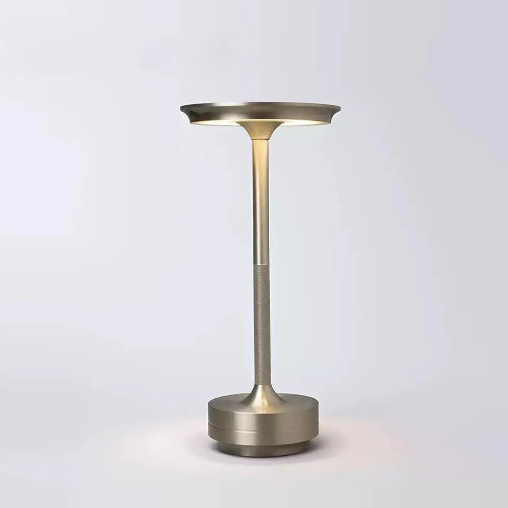 Brass-colored outdoor light fixture on a white background