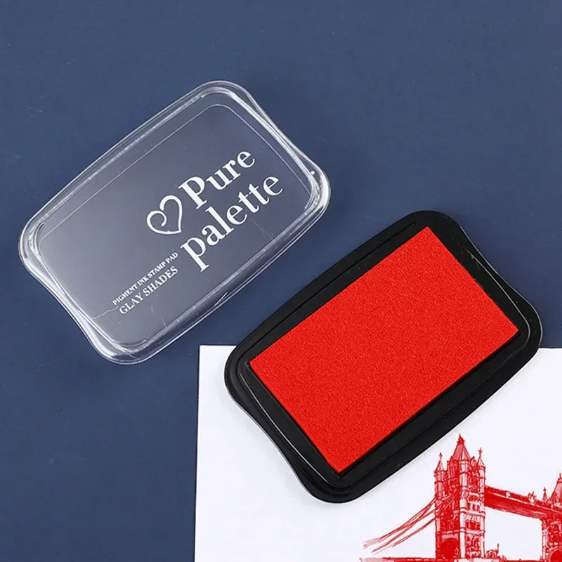Red ink pad with 'Pure Palette' branding on a blue background