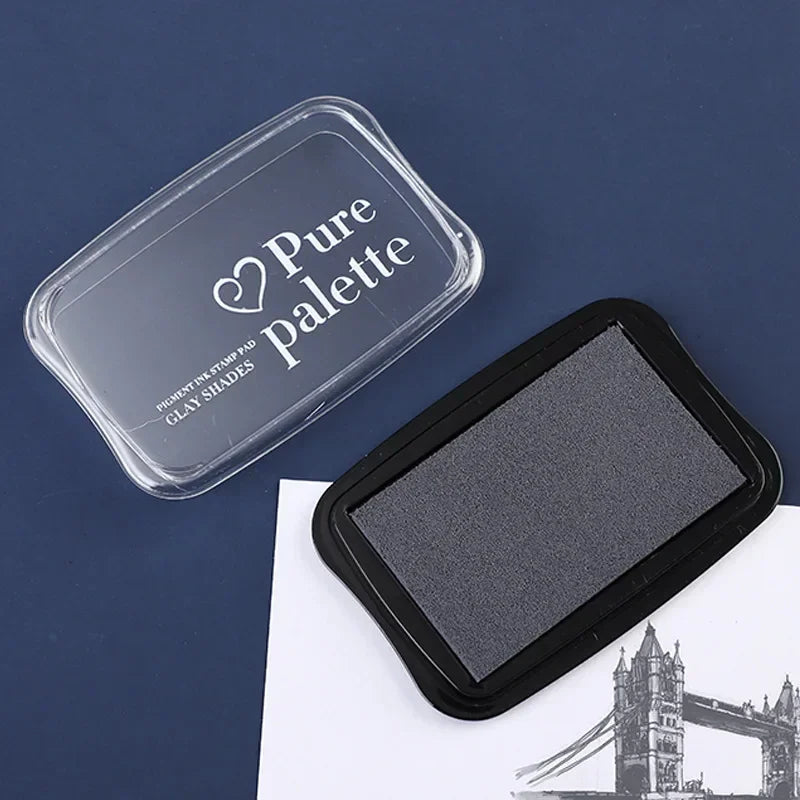 Gray ink pad with 'Pure Palette' container on a blue background