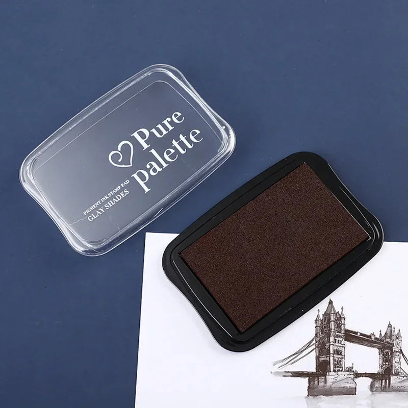 Brown ink pad with 'Pure Palette' container on a blue background