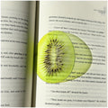 Sliced kiwi fruit on an open book