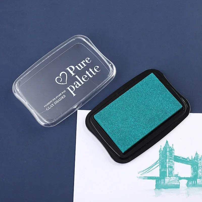 Green ink pad with 'Pure Palette' container on a dark blue background