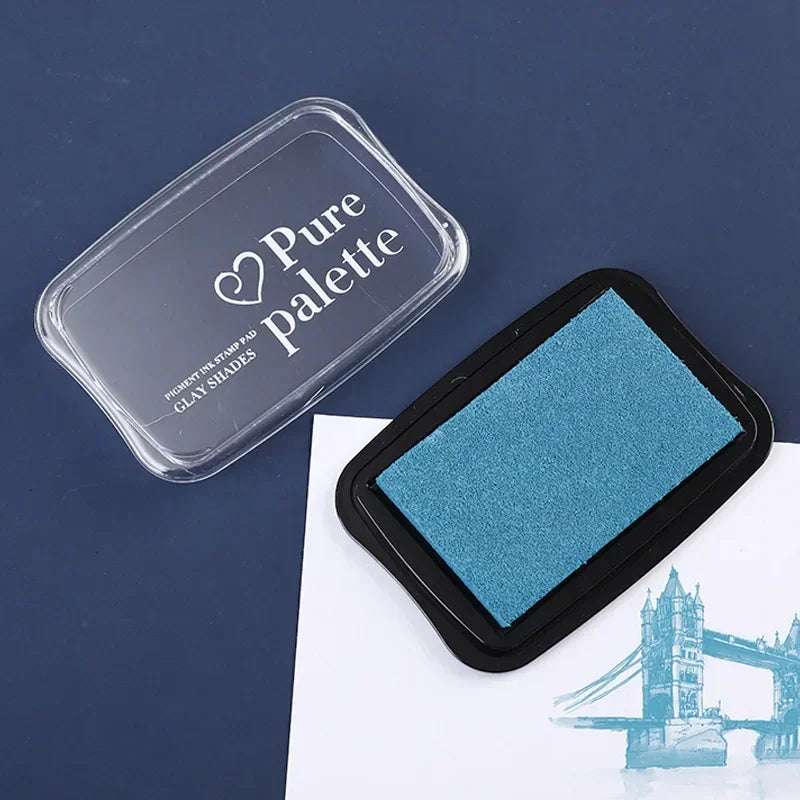 Blue ink pad with 'Pure Palette' container on a dark blue background