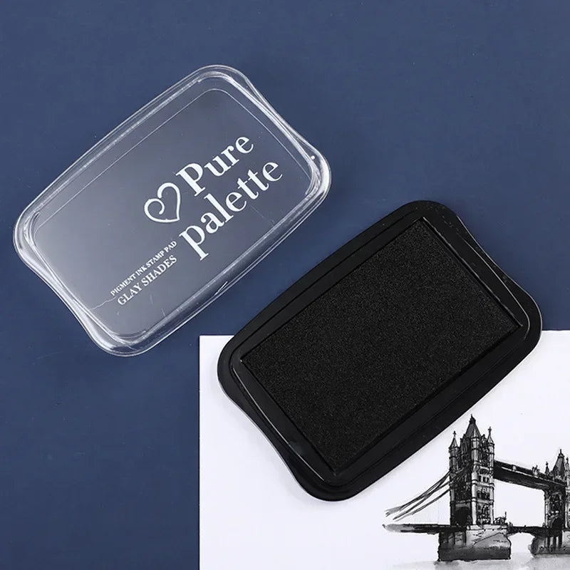 Black ink pad with 'Pure Palette' lid on a blue background