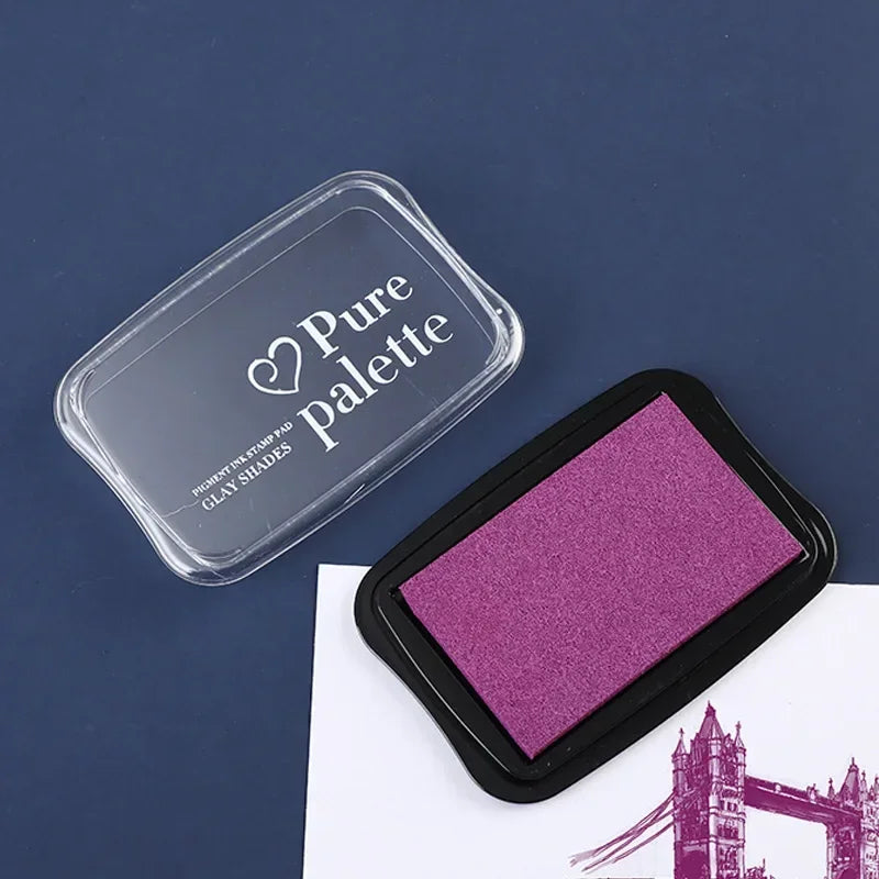 Purple ink pad with 'Pure Palette' container on a dark blue background