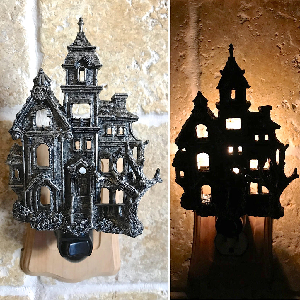 Halloween-themed house-shaped night light on a neutral background