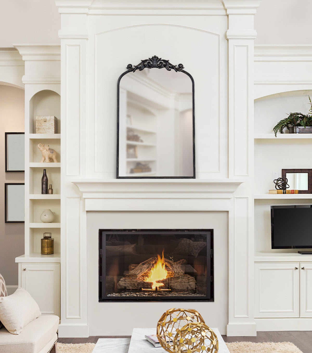 Living room with a white fireplace and built-in shelves.